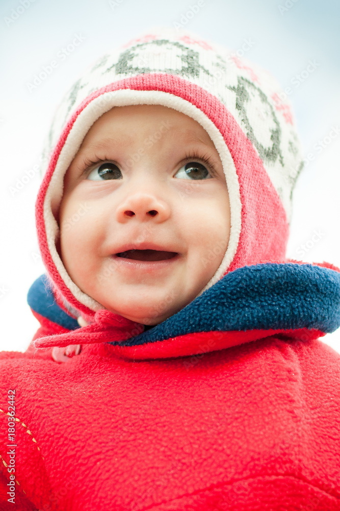 child in hat and in red jacket close-up child in hat and in red jacket close-up