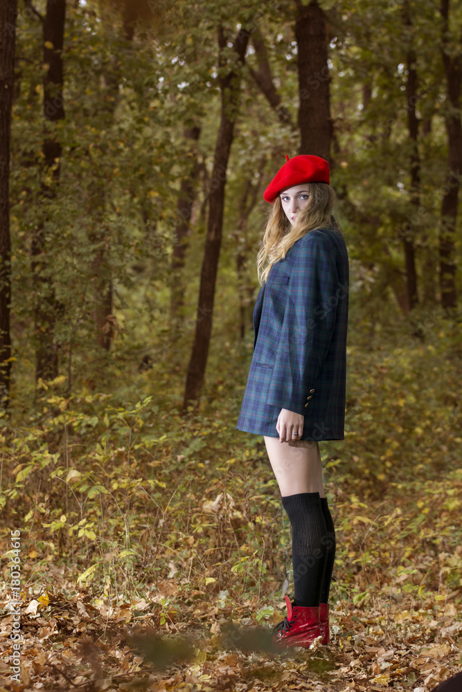 Young woman looking happy in forest in an autumn day Young woman looking happy in forest in an autumn day