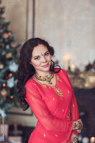 brunette girl in the national Indian costume from a Christmas tree