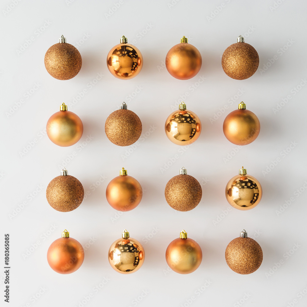 Golden Christmas baubles decoration on bright background. Flat lay. Holiday concept. Golden Christmas baubles decoration on bright background. Flat lay. Holiday concept.