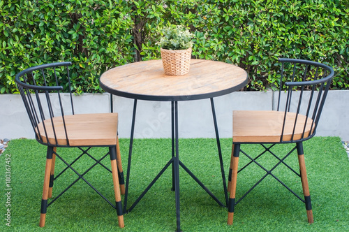Modern coffee and tea table set with chairs and flower rattan basket, no smoking table sign lay on table in smoking area