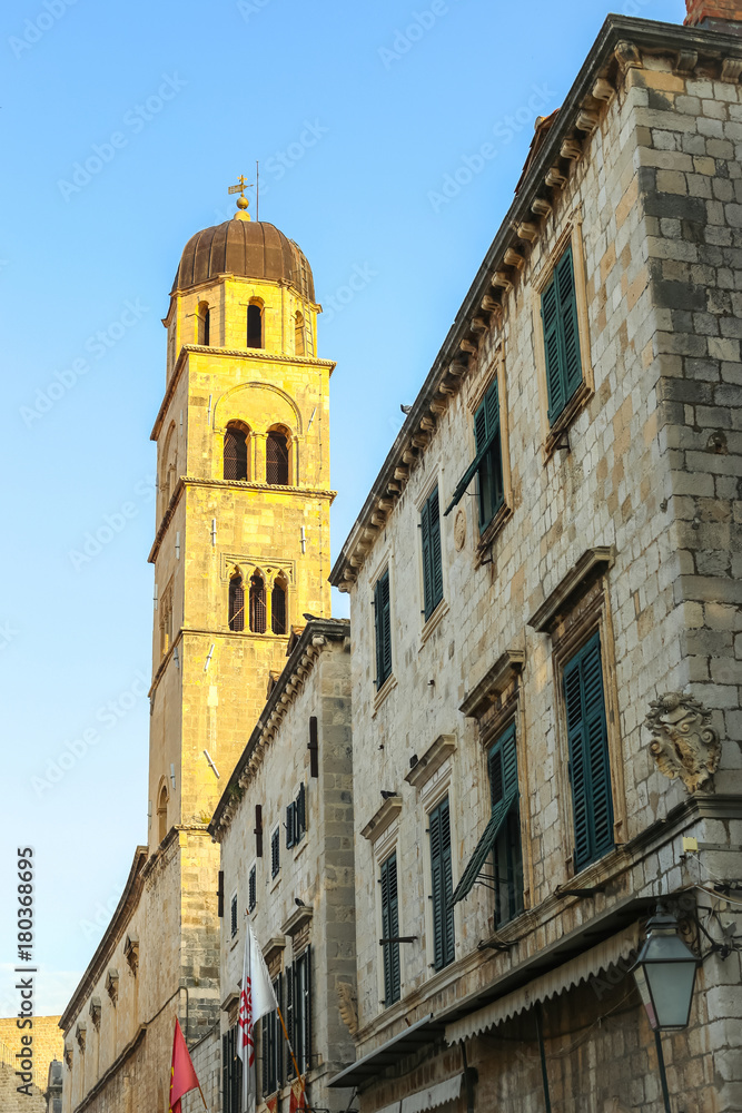 The bell tower of the Franciscan church and monastery in the main city street Stradun in Dubrovnik, Croatia.
