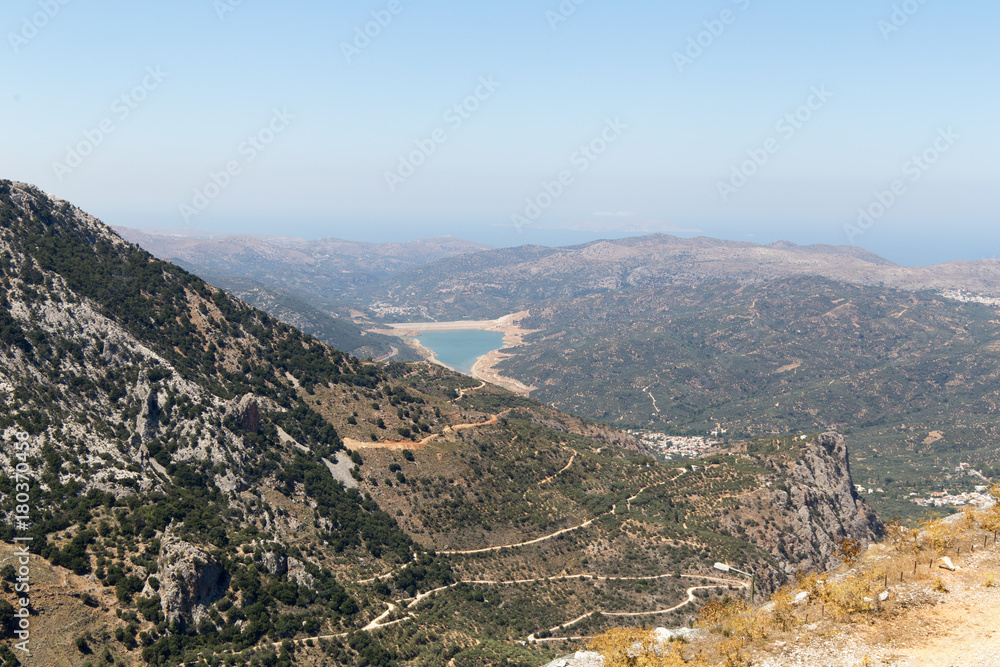 Summer mountain path and a lake in valley in Crete, Greece