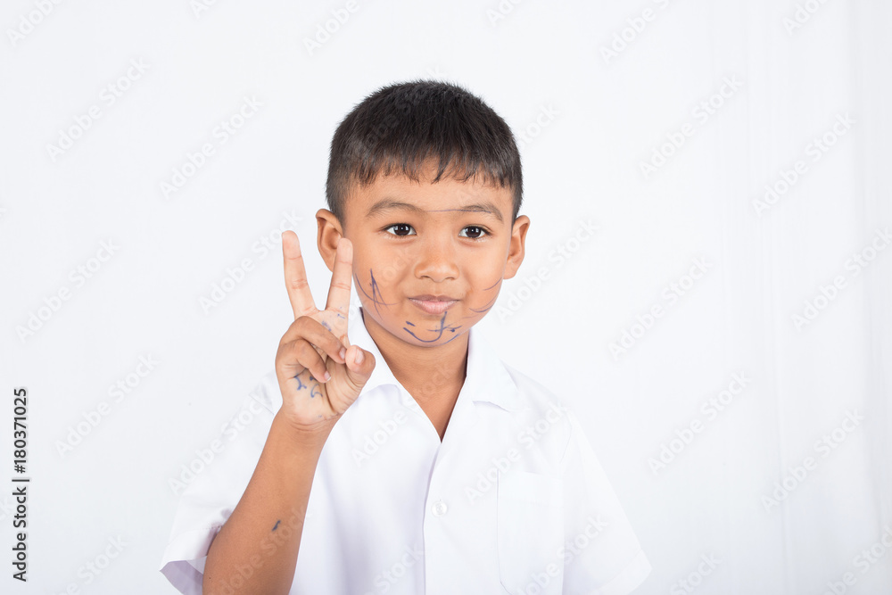 Cute asian boy painting color on face on white background Cute asian boy painting color on face on white background