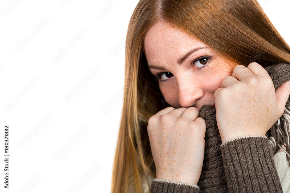 Portrait of a beautiful young woman in a sweater on a white background. Face close up Portrait of a beautiful young woman in a sweater on a white background. Face close up