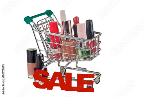 Cosmetics in the shopping cart for purchases isolated on white