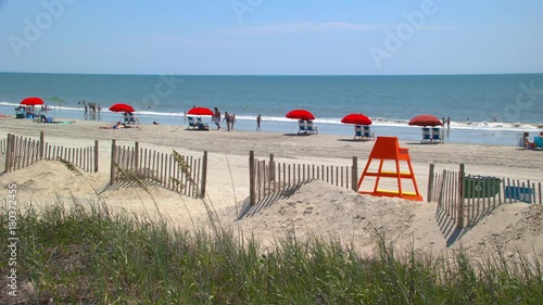 Generic Vibrant Oceanside Scene in Myrtle Beach SC with Visiting People on Vacation Swimming Sunbathing and Relaxing on the Sand of the Popular South Carolina Destination on the East Coast photo