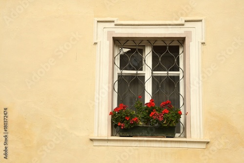 windows with red flowers in the centre of Brixen Bressanone  Bolzano. Italy.