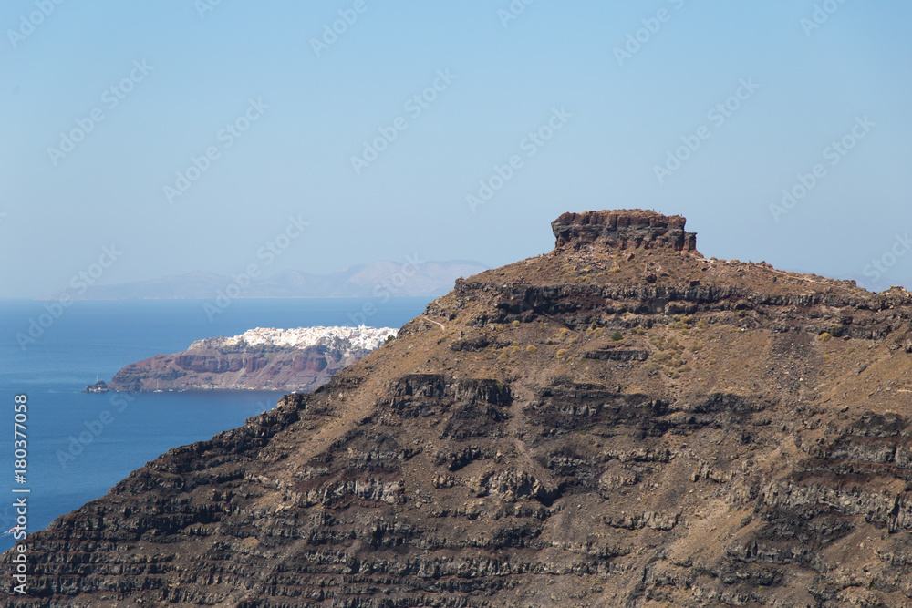 Mountain hill with flat top with a sea at the Greek island Santorini in city of Thira