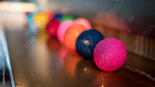 Decoration Detail of Coloful Small Spheres with light inside them  on wooden table