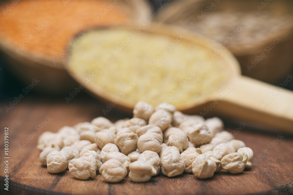 Heap Of Chickpeas On A Wooden Surface, Other Legumes On Background Heap Of Chickpeas On A Wooden Surface, Other Legumes On Background