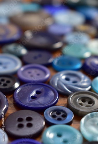 blue sewing buttons on a wood table