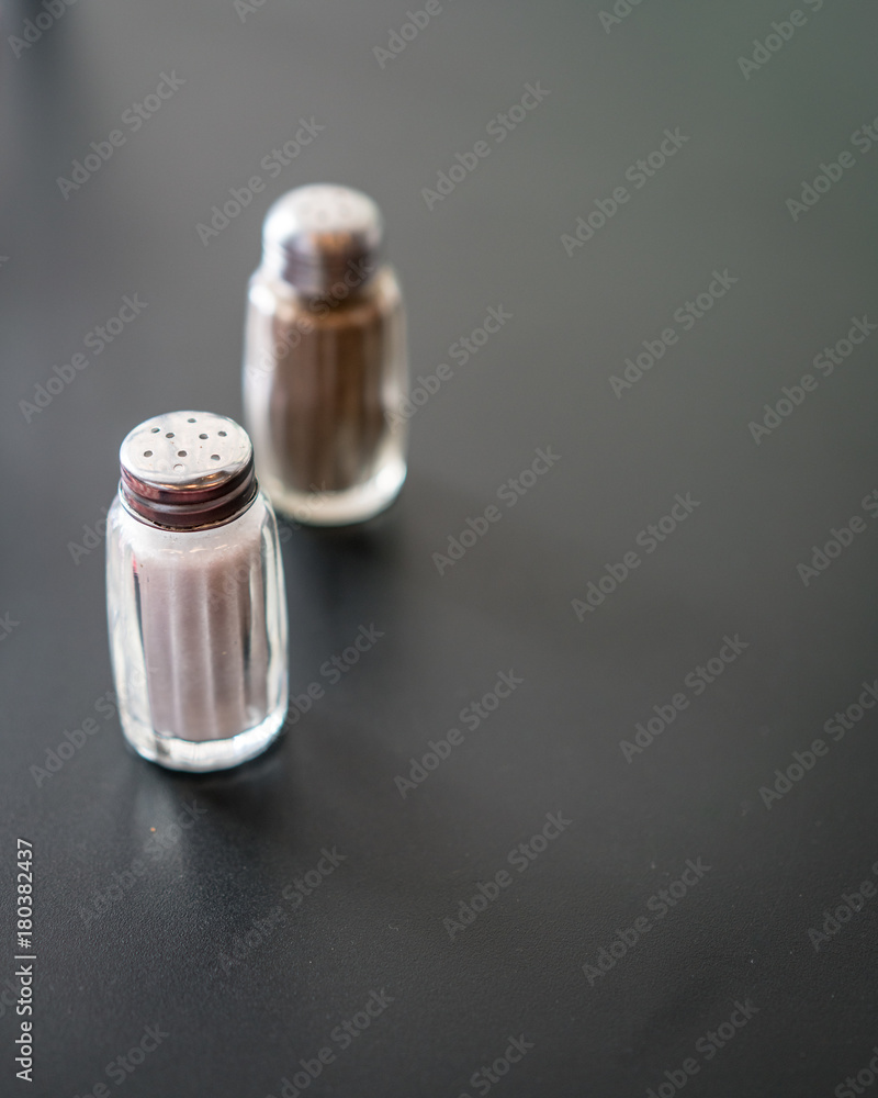 Salt and Pepper on Dark Grey Surface Salt and Pepper on Dark Grey Surface