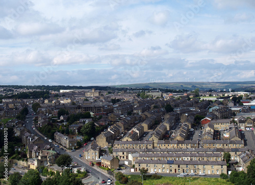 aerial view of halifax in yorkshire with the pennines on the horizon showing rows of houses and sky © Philip J Openshaw 