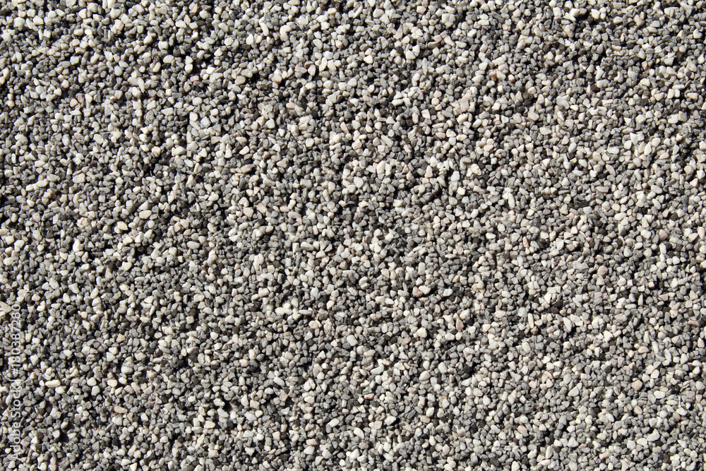 Black and white small round grains covering a vertical wall surface Black and white small round grains covering a vertical wall surface