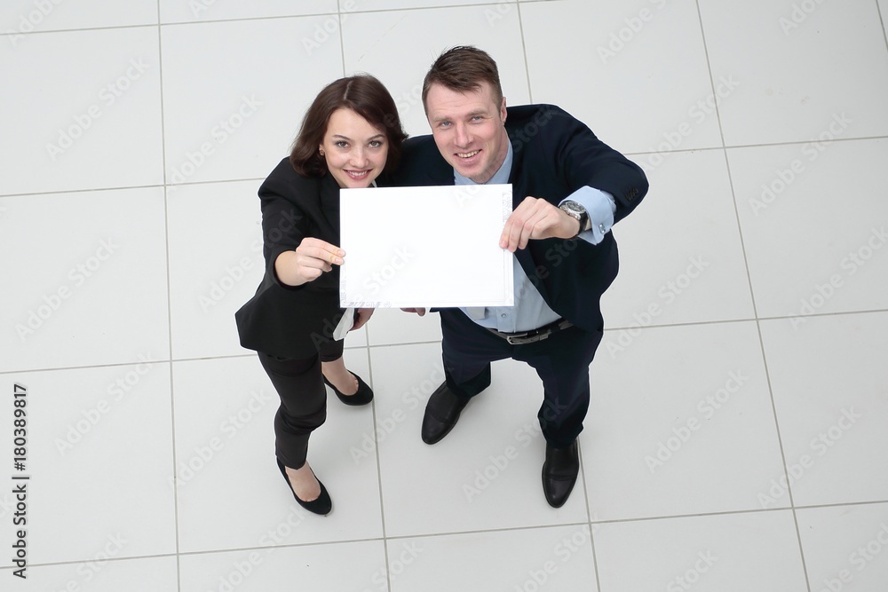 businessman and business woman with blank sheet businessman and business woman with blank sheet