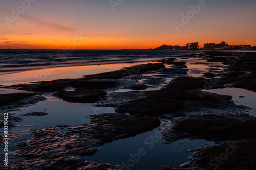 Sunset over a rocky beach in front the hotels at Puerto Penasco  Rocky Point  Mexico.