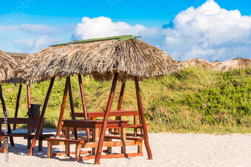 Fototapeta Naklejka Na Ścianę i Meble -  View of a gazebos on a sandy beach, Varadero, Matanzas, Cuba. Copy space for text.