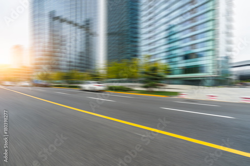 blurred empty urban road and modern buildings