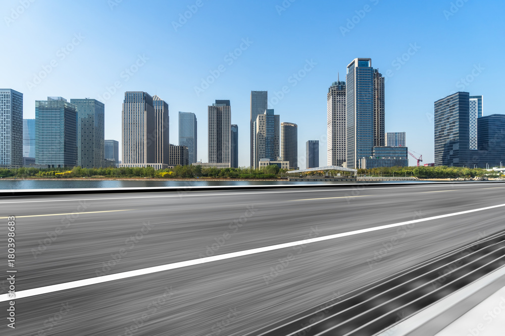empty asphalt road with city skyline background in china.. empty asphalt road with city skyline background in china..
