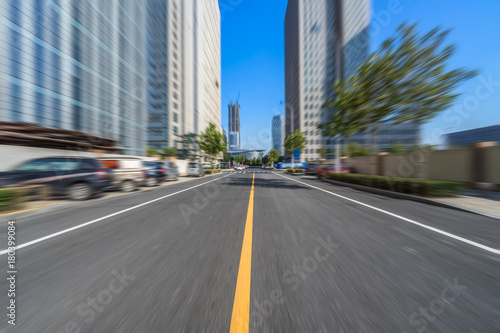 empty city road through the modern buildings