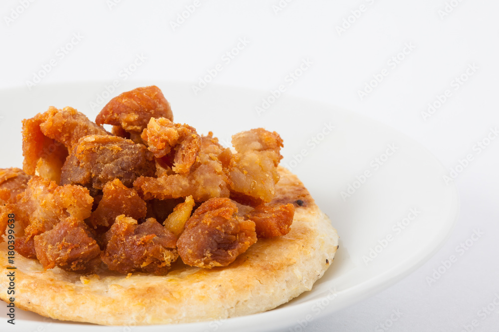Traditional Colombian arepa topped with pork rind Traditional Colombian arepa topped with pork rind