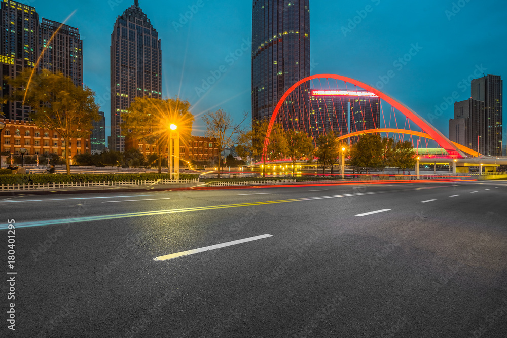 Fototapeta premium Empty asphalt road through modern city at night, China.