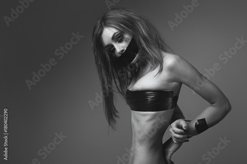 white Caucasian girl freckles posing sexy attractive in studio mouth and hands taped messy hair makeup photo