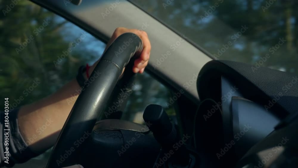 Inside a car. A man's hands on the steering wheel. Close-up shot Inside a car. A man's hands on the steering wheel. Close-up shot