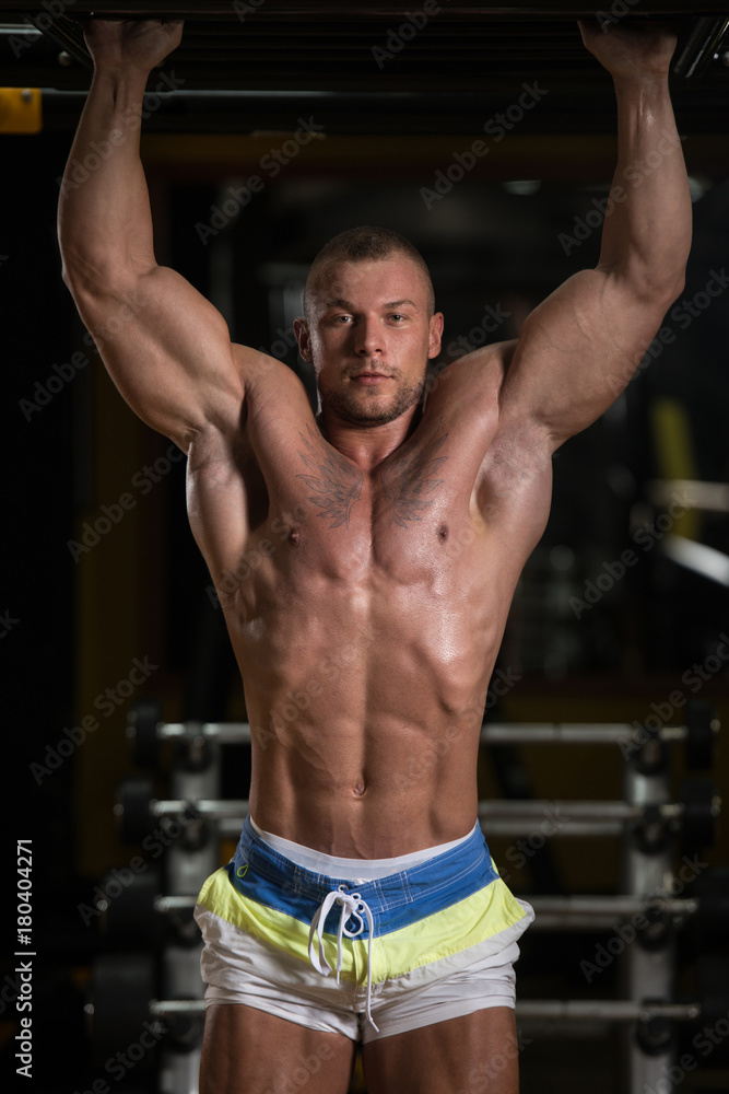 Handsome Muscular Man Flexing Muscles In Gym Handsome Muscular Man Flexing Muscles In Gym