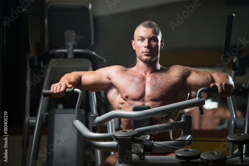 Bodybuilder Exercising Back In Gym