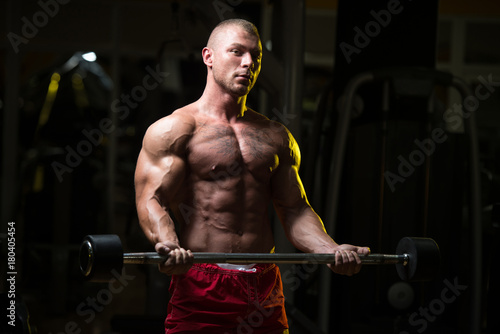 Man In The Gym Exercising Biceps With Barbell © Jale Ibrak