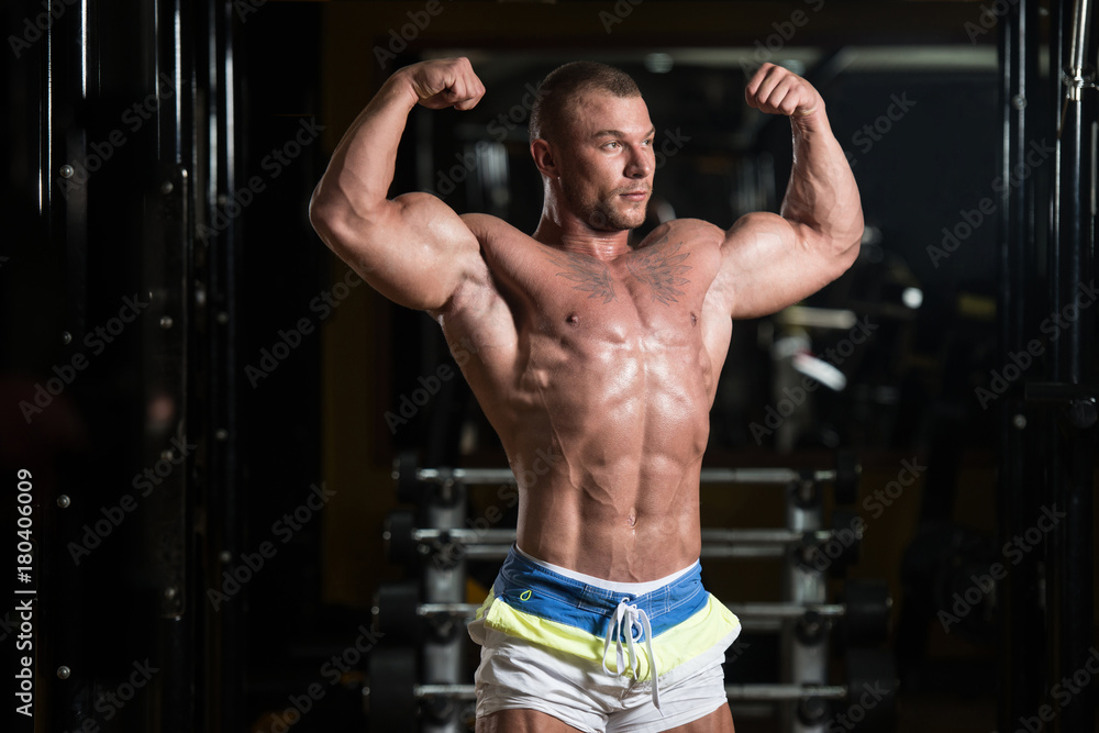 Bodybuilder Posing Biceps After Exercises Bodybuilder Posing Biceps After Exercises