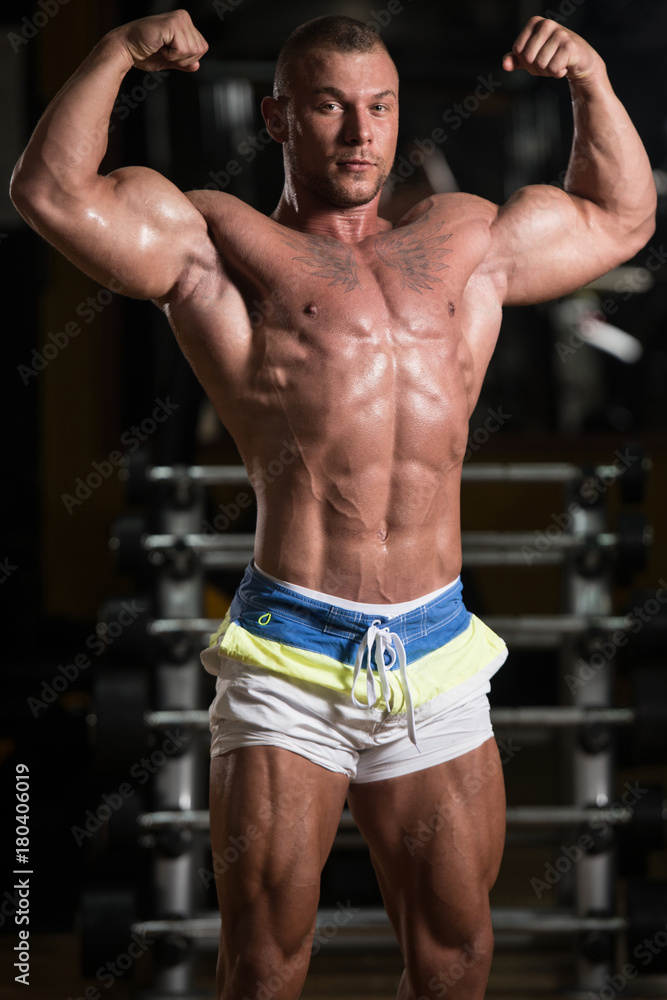Bodybuilder Posing Biceps After Exercises Bodybuilder Posing Biceps After Exercises