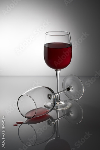 glasses of wine with a drop on the table on a background