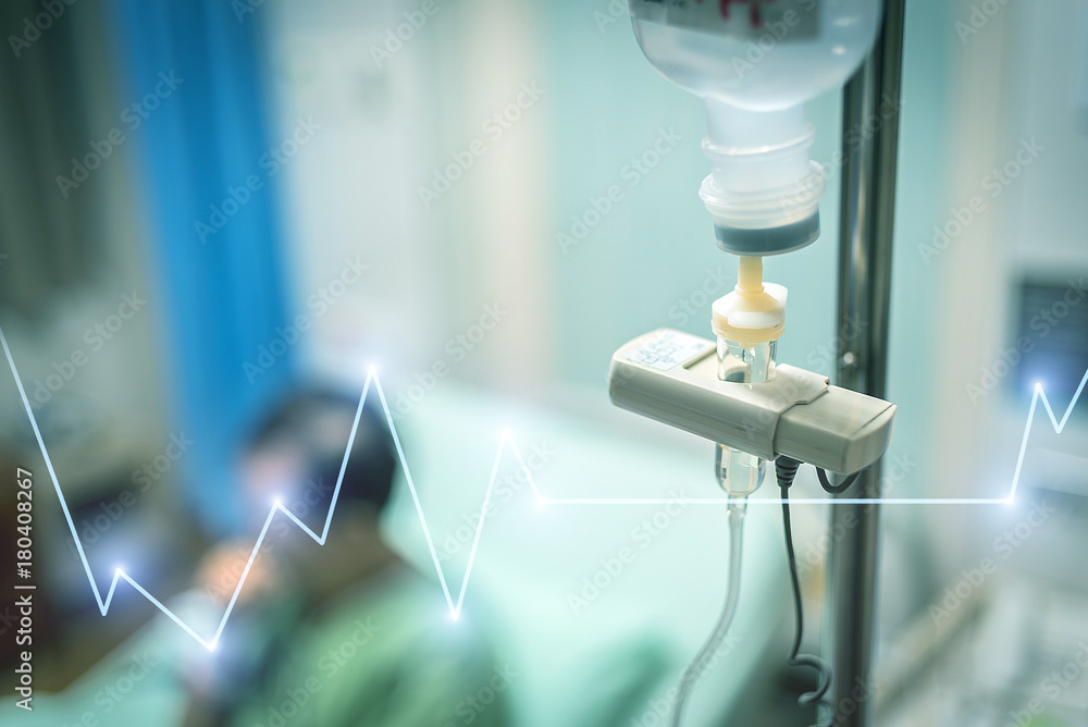 Close up saline solution drip for patient and infusion pump in hospital with heart rate graphic, Treatment of the disease of the doctor concept. Close up saline solution drip for patient and infusion pump in hospital with heart rate graphic, Treatment of the disease of the doctor concept.