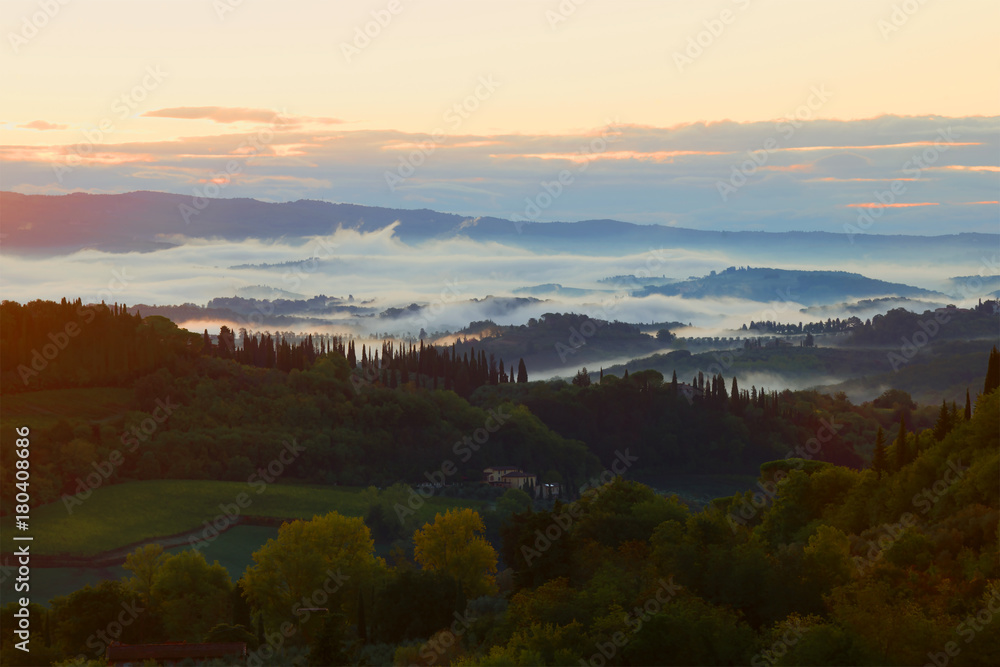 A foggy September morning in the vicinity of the city of San Gimignano. Tuscany, Italy