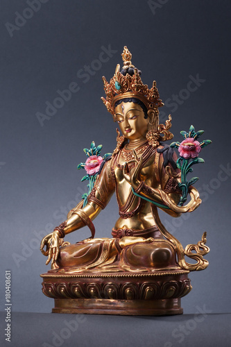 Bronze figurine of a green Tara full of wisdom. photo