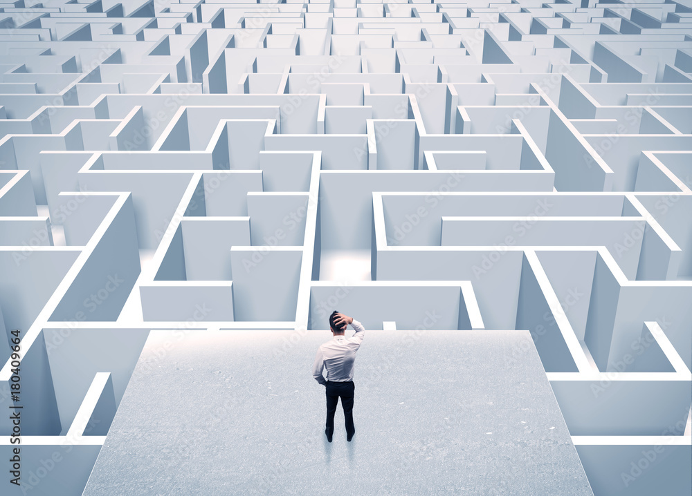 Businessman staring at infinite maze Businessman staring at infinite maze