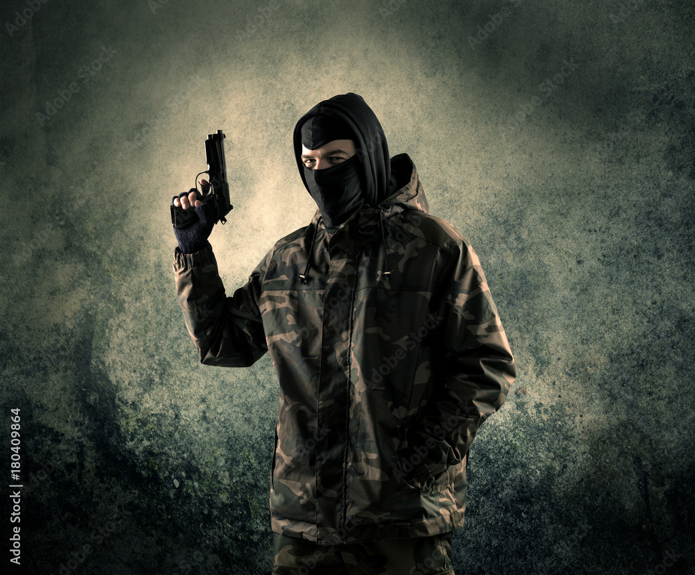 Portrait of a heavily armed masked soldier with grungy background Portrait of a heavily armed masked soldier with grungy background