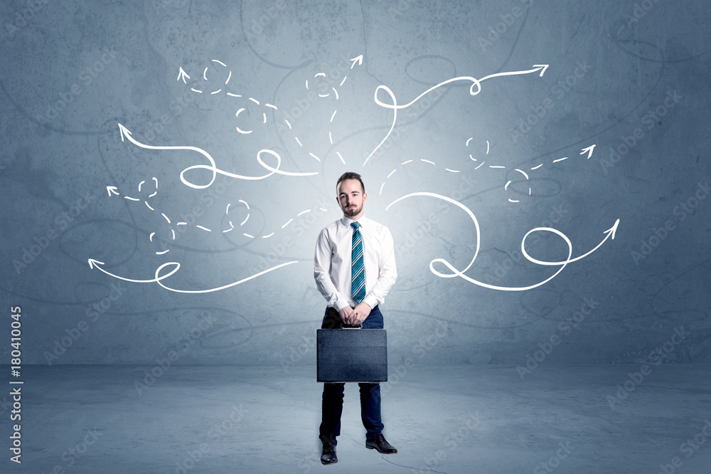 Businessman standing with winding arrows around Businessman standing with winding arrows around
