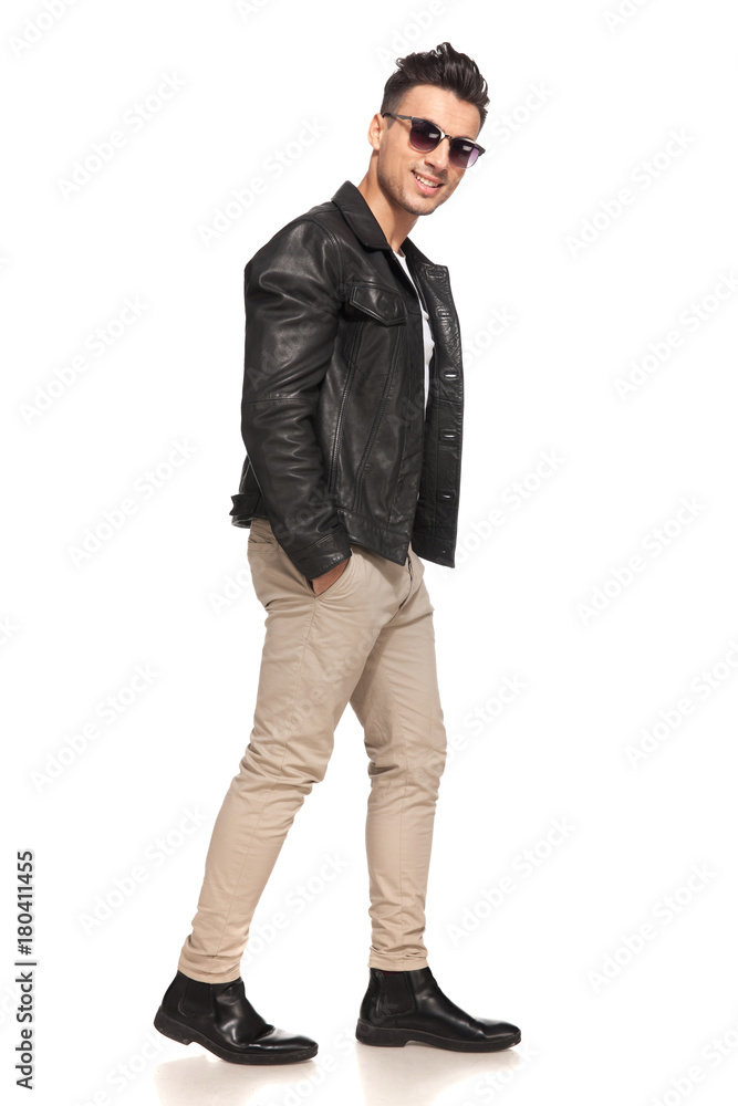 happy smiling fashion man walking with hands in his pockets happy smiling fashion man walking with hands in his pockets