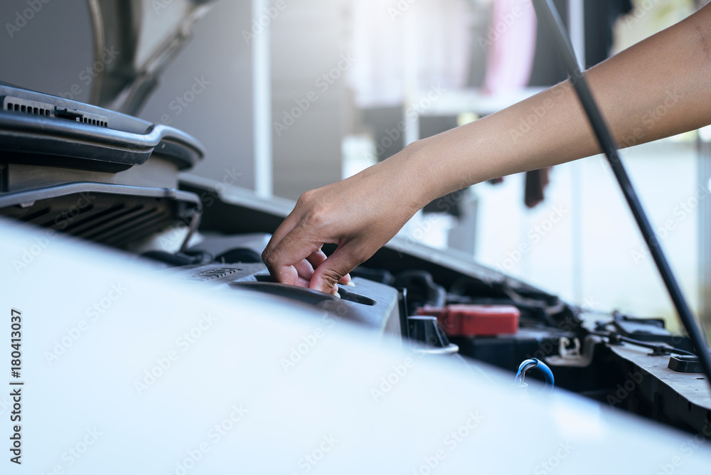Mechanic changing oil mechanic car with open hood Mechanic changing oil mechanic car with open hood