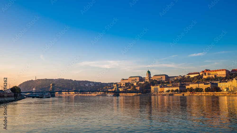 Budapest, Hungary - Golden surise over the River Danube with Szechenyi Chain Bridge, Buda Castle Royal Palace, Gellert Hill and Statue of Liberty at background