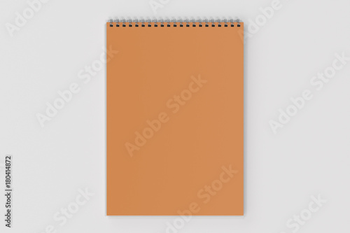 Blank orange notebook with metal spiral bound on white background