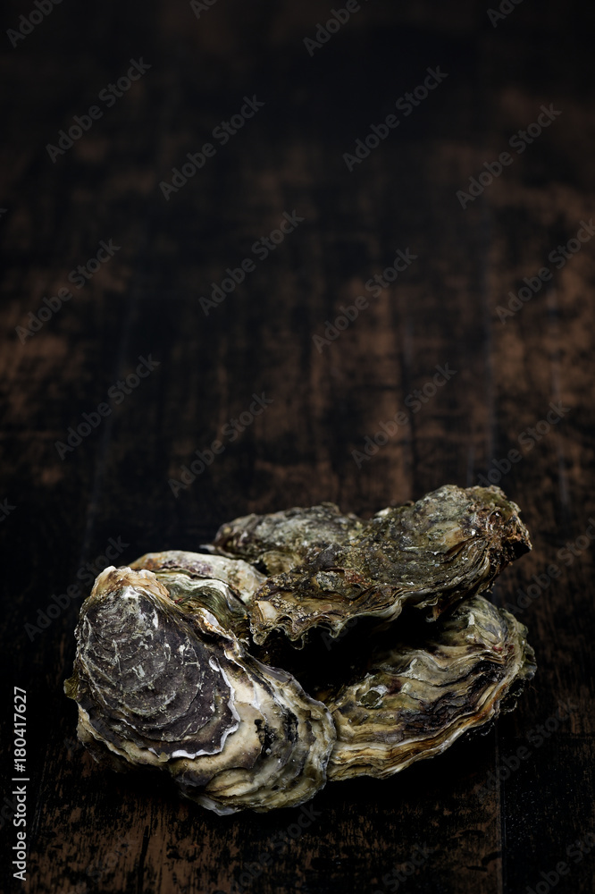 Raw oysters on the wooden table, background Raw oysters on the wooden table, background