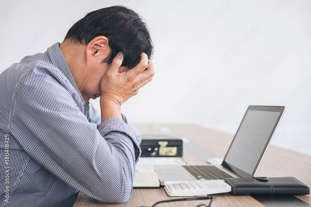 Image of Frustrated stressed business man and graph business with computer laptop in the workplace Image of Frustrated stressed business man and graph business with computer laptop in the workplace