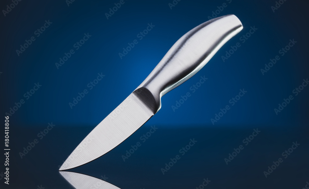 Obraz premium steel kitchen knife on the blue