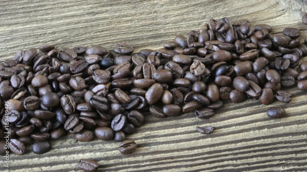 Raw coffee beans. Coffee beans on wood background. 
