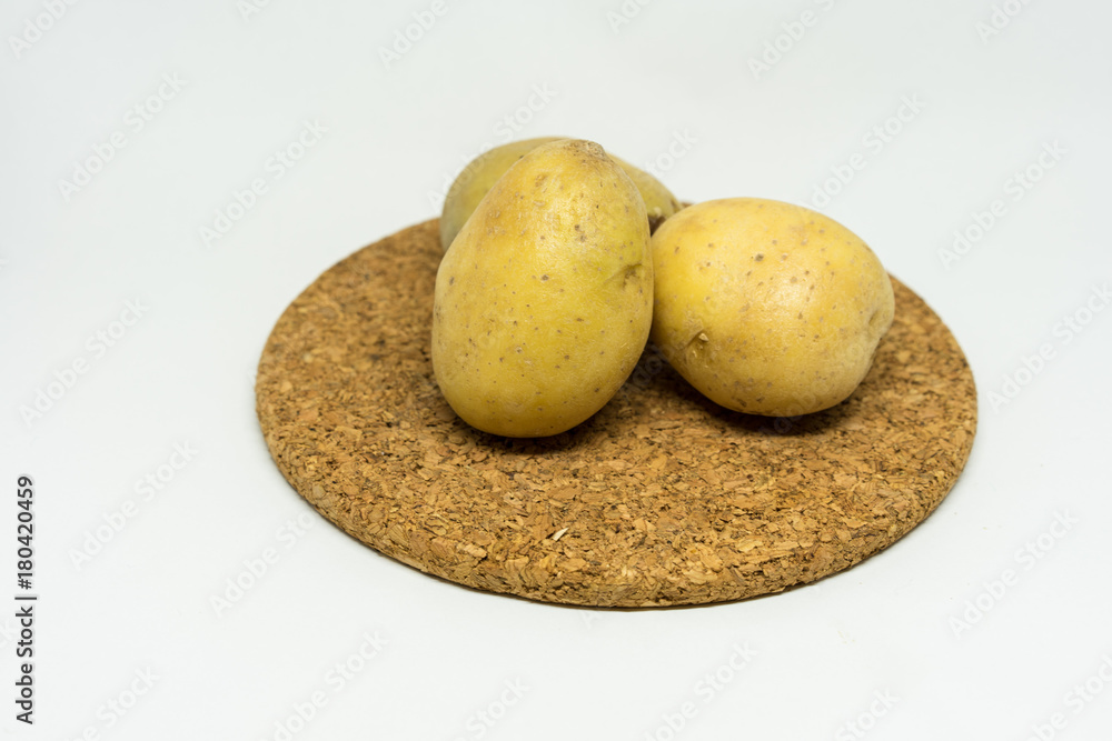 Fototapeta premium two patato isolated on cork with white background